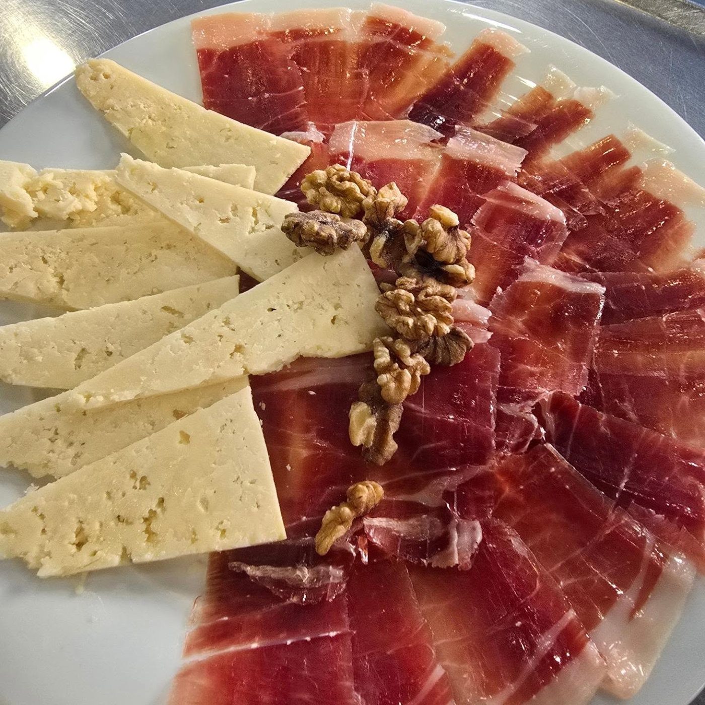 Board of Iberian ham, cured cheese and walnuts
